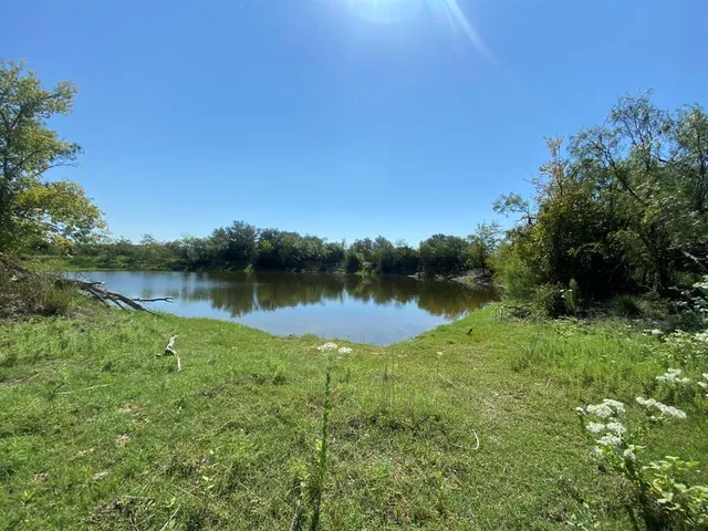a view of a lake in between two chairs