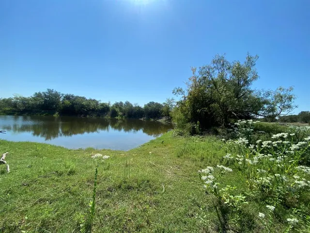 a view of a lake with houses in background