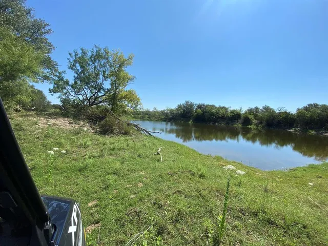 a view of a lake with houses in the back