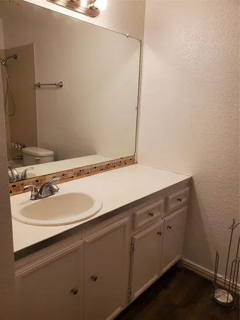 a view of a room that has wooden floor and a window