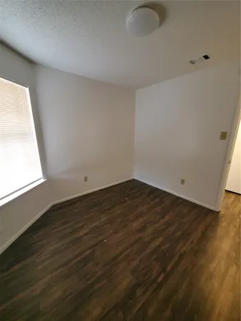 an empty room with wooden floor