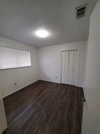 a view of an empty room and wooden floor