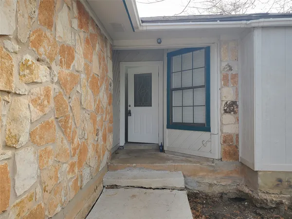 an empty room with wooden floor and fireplace