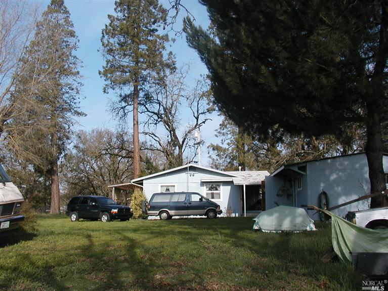 1720 Olivet Road Santa Rosa, CA 95401 - Photo 1 of 1 a view of a white house with a big yard and large trees