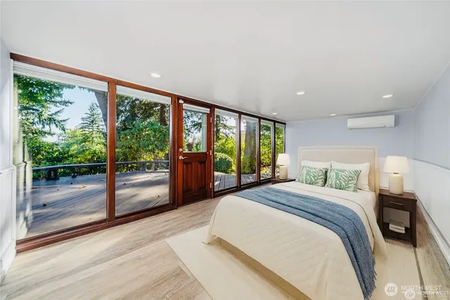 a bedroom with a large bed and a large window