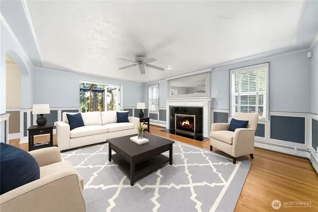 a living room with furniture a rug and a fireplace