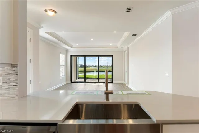 a kitchen with a sink and a large window