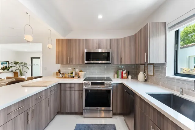 a kitchen with a sink stove top oven and refrigerator