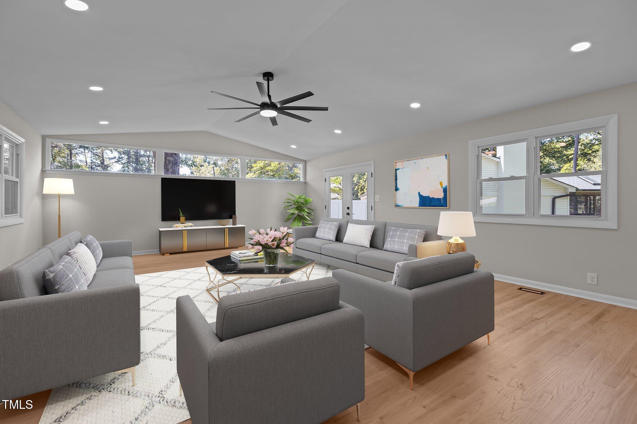 2505 Catalina Court Raleigh, NC 27607 - Photo 11 of 25 a living room with furniture a ceiling fan and a flat screen tv