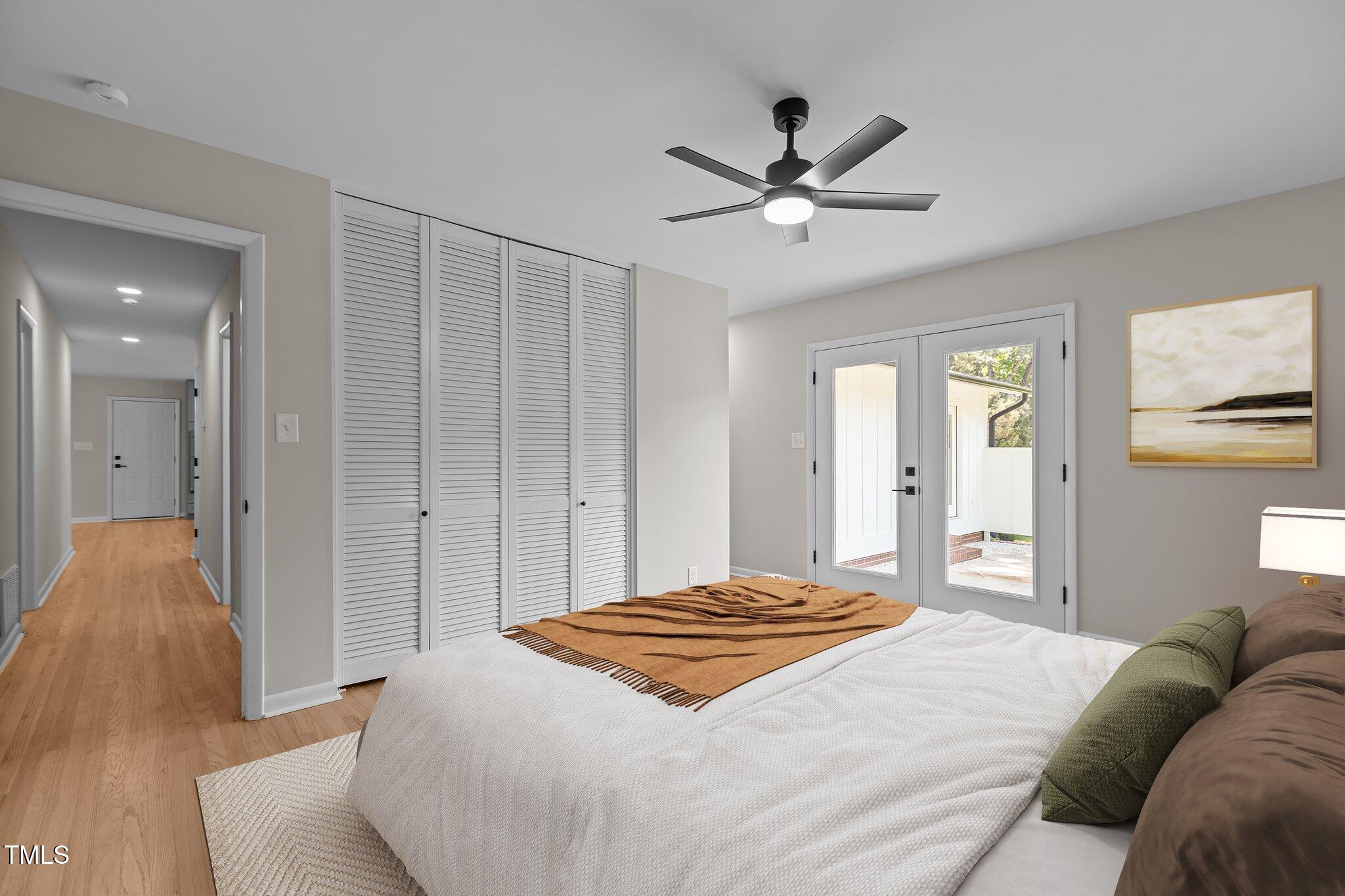 2505 Catalina Court Raleigh, NC 27607 - Photo 13 of 25 a bedroom with a large bed and a chandelier