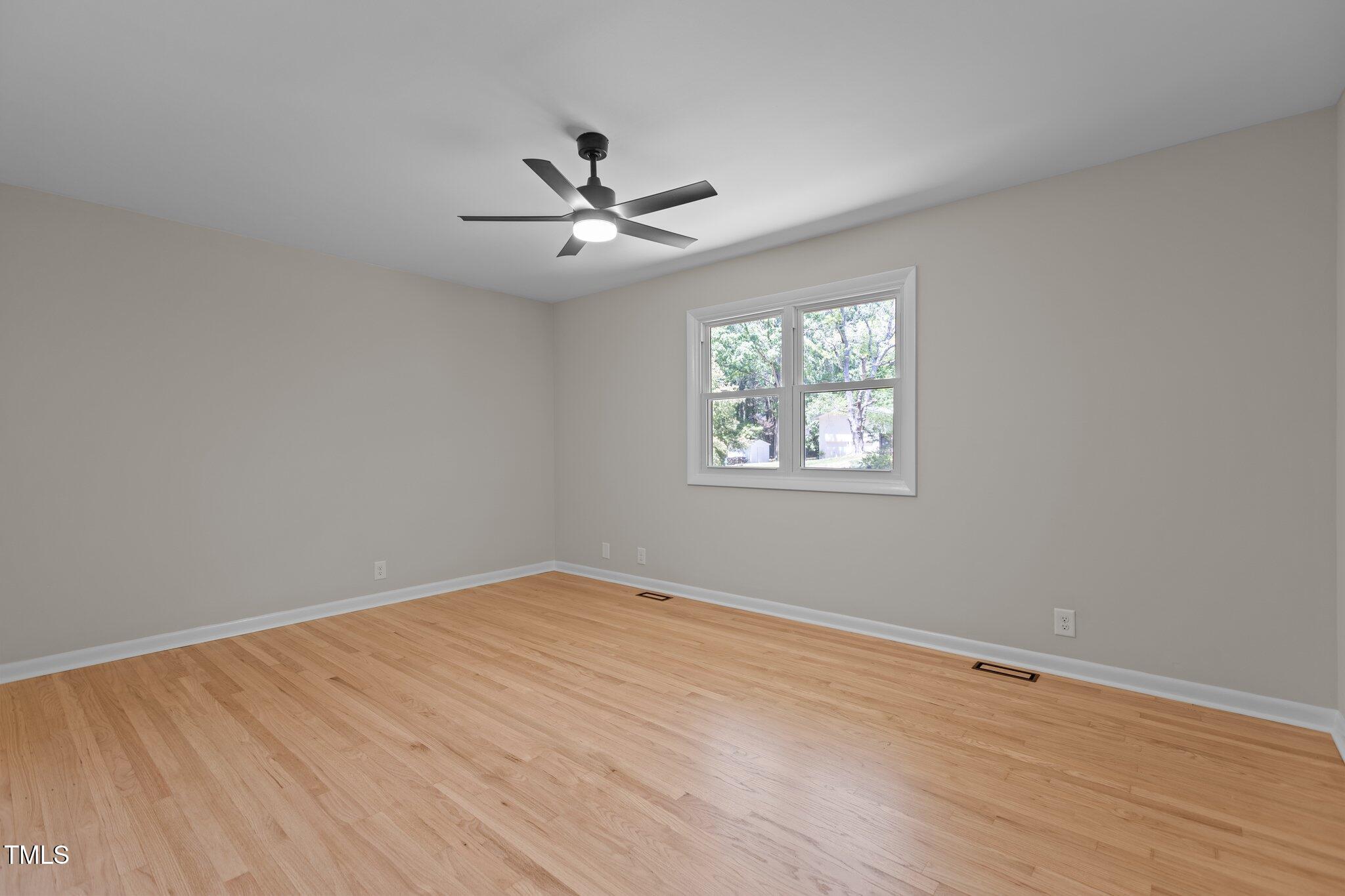 2505 Catalina Court Raleigh, NC 27607 - Photo 16 of 25 a view of empty room with wooden floor and fan