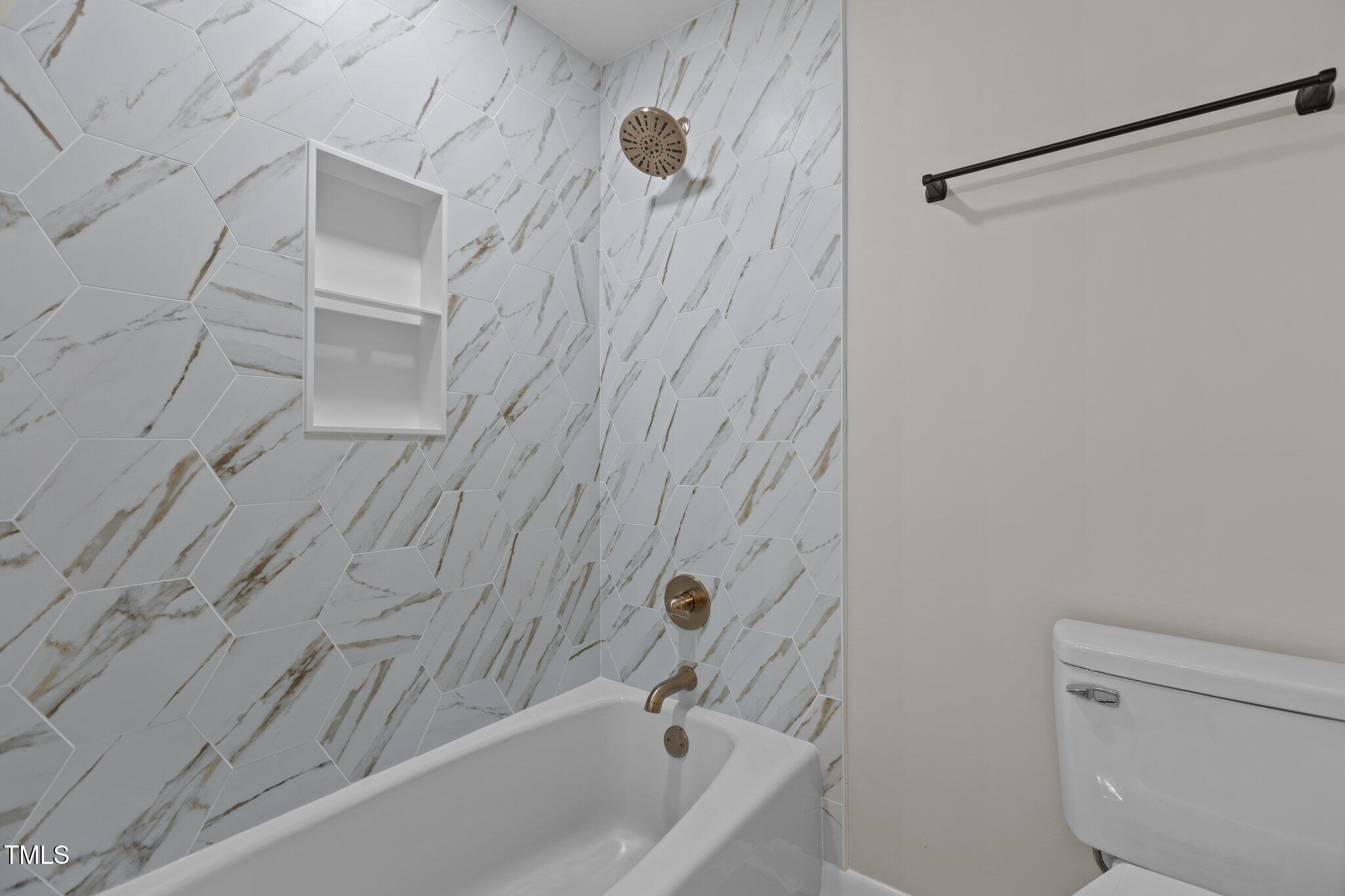 2505 Catalina Court Raleigh, NC 27607 - Photo 19 of 25 a bathroom with a bathtub and a toilet