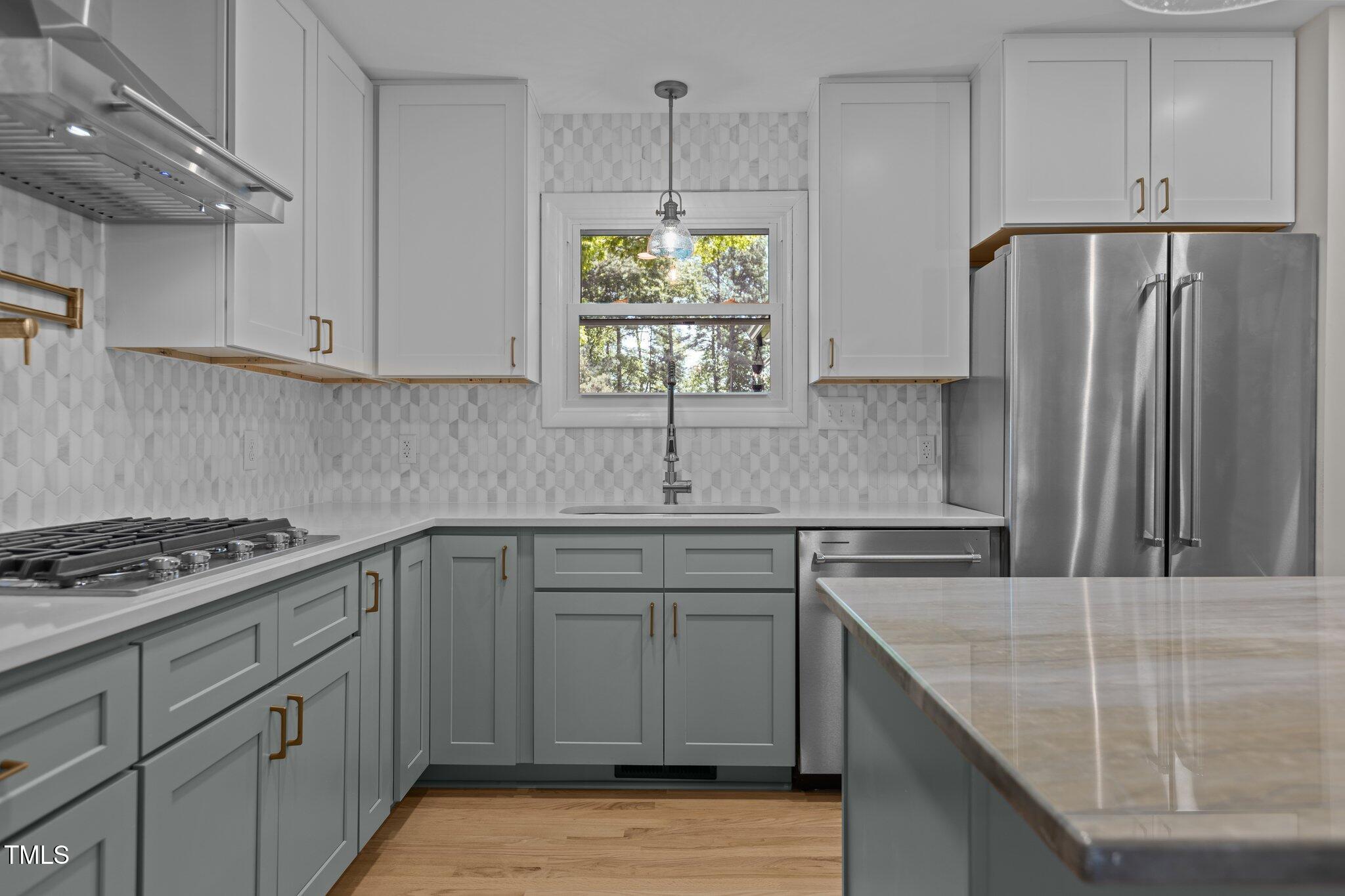 2505 Catalina Court Raleigh, NC 27607 - Photo 3 of 25 a kitchen with stainless steel appliances granite countertop a sink stove and refrigerator