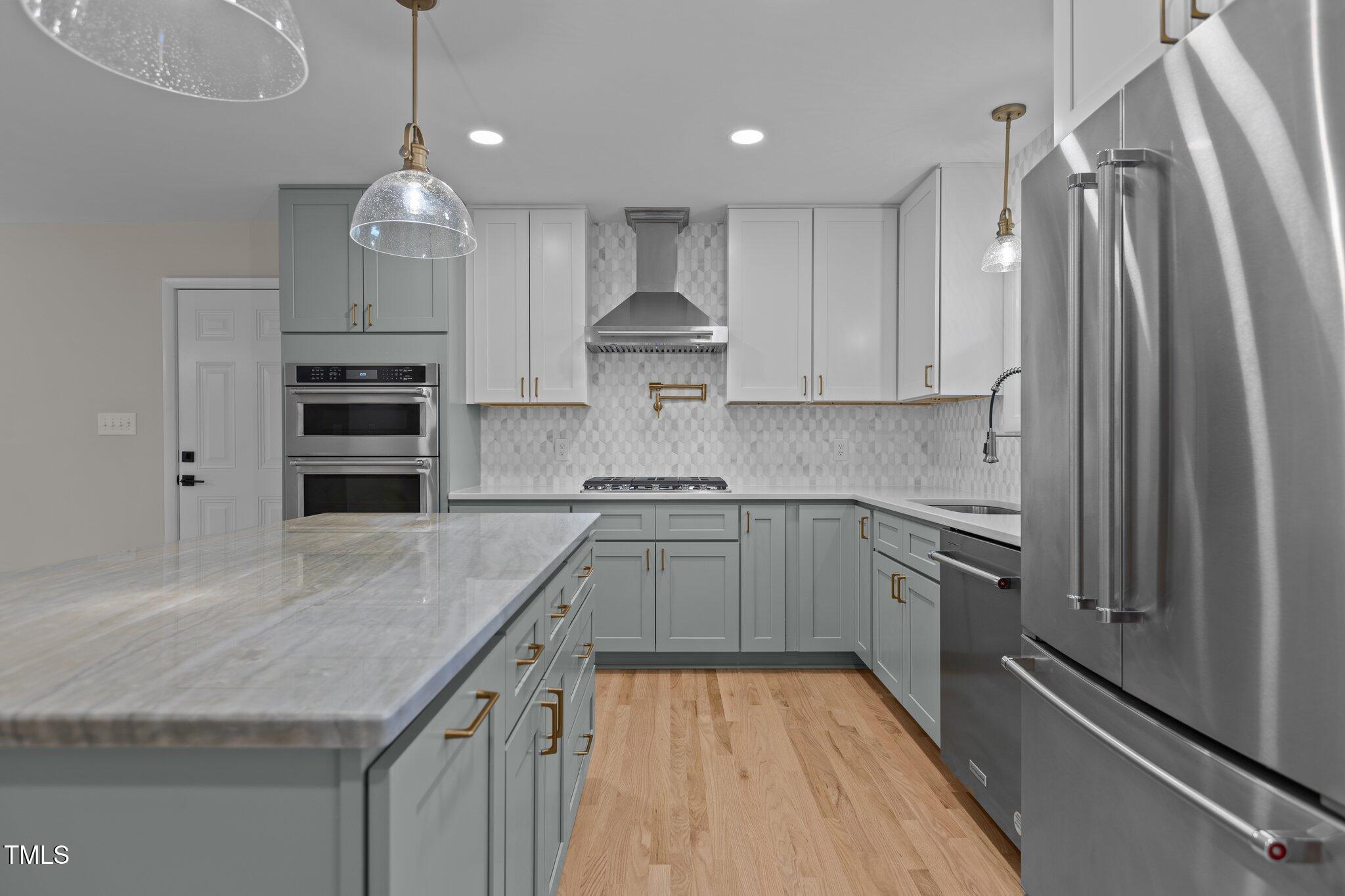 2505 Catalina Court Raleigh, NC 27607 - Photo 5 of 25 a kitchen with stainless steel appliances granite countertop a sink refrigerator and cabinets