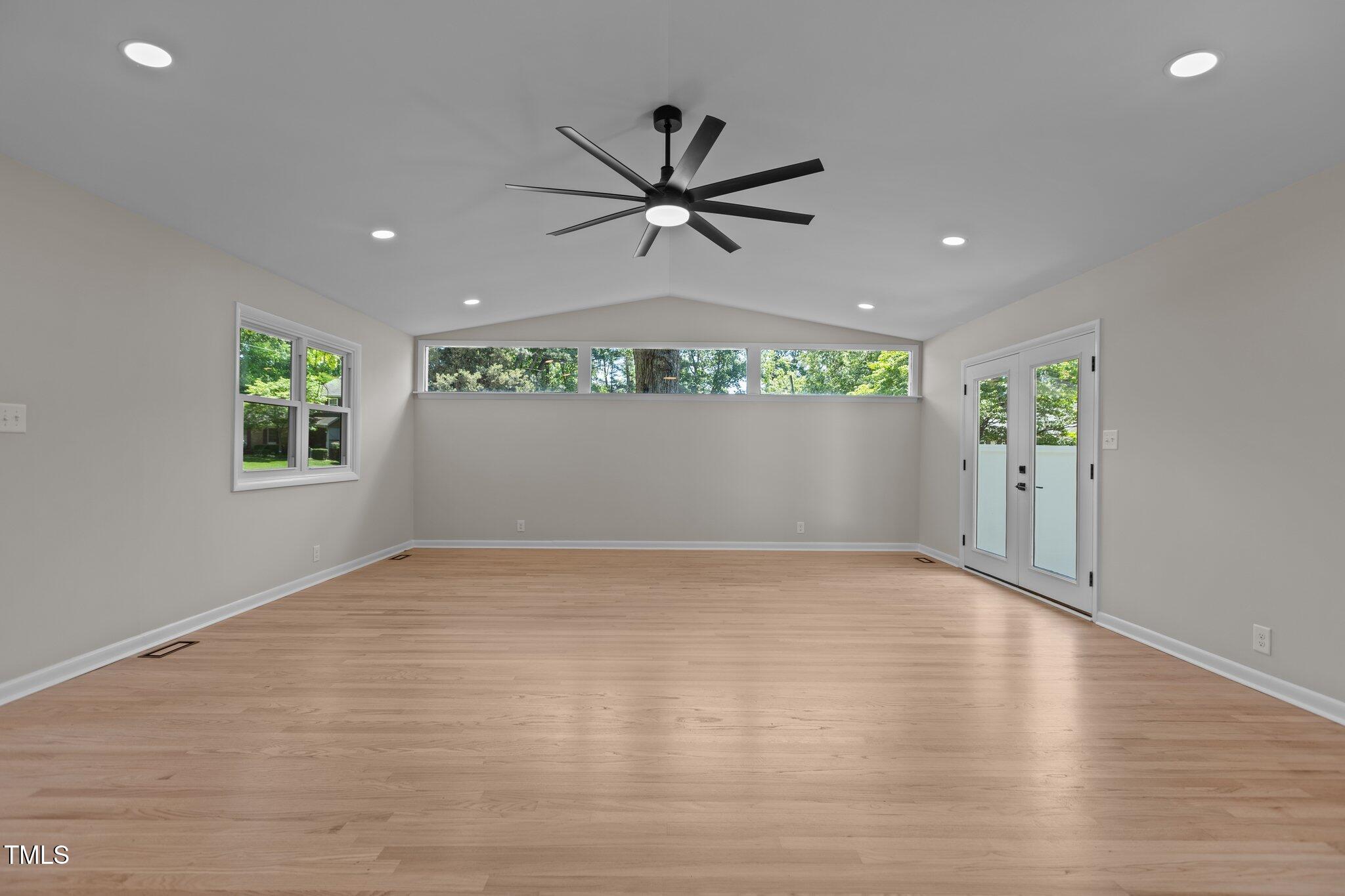 2505 Catalina Court Raleigh, NC 27607 - Photo 10 of 25 an empty room with windows and ceiling fan