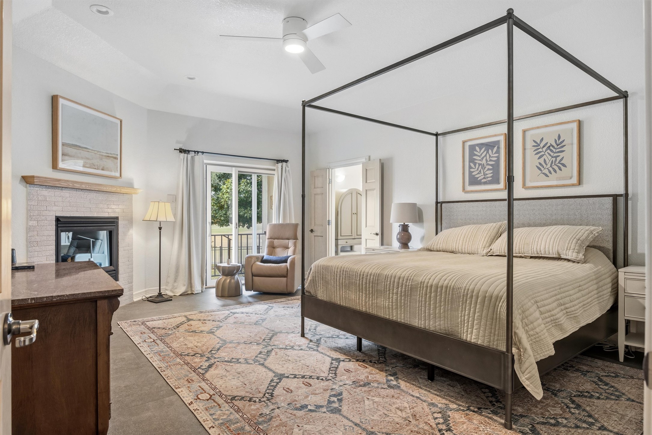 700 Shadow Hill Road Horseshoe Bay, TX 78657 - Photo 14 of 23 a bedroom with a large bed and a chandelier