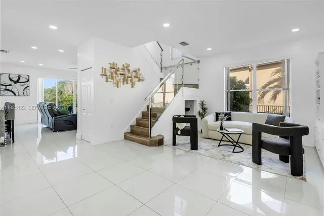 a living room with furniture and stairs