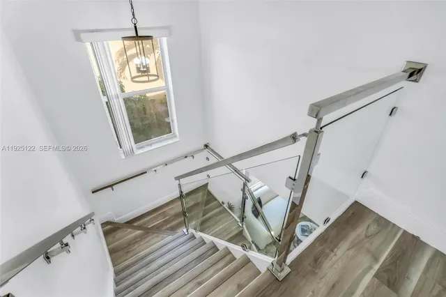 a view of entryway and kitchen with wooden floor