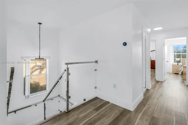 a view of an entryway with wooden floor and a livingroom view