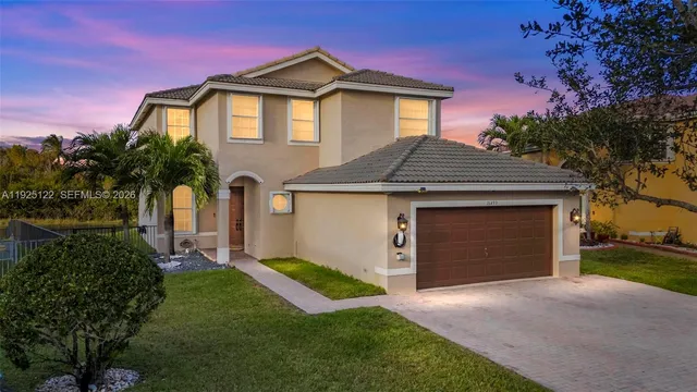 a front view of a house with a yard and garage