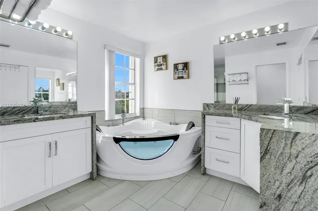 a room with granite countertop a sink and cabinets
