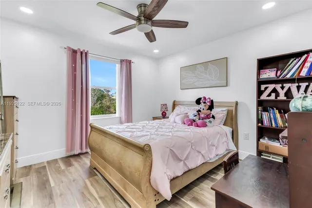 a bedroom with a bed and a book shelf