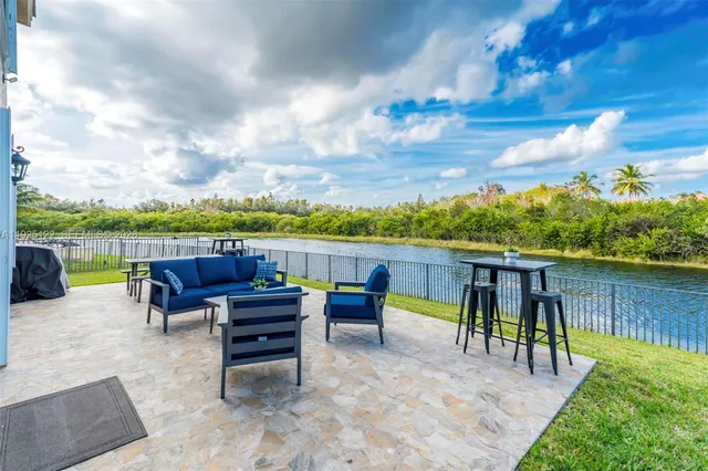 a view of chairs and table in the patio