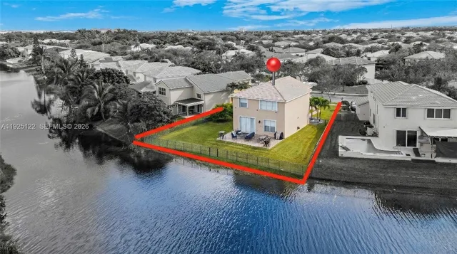 an aerial view of a houses with a road
