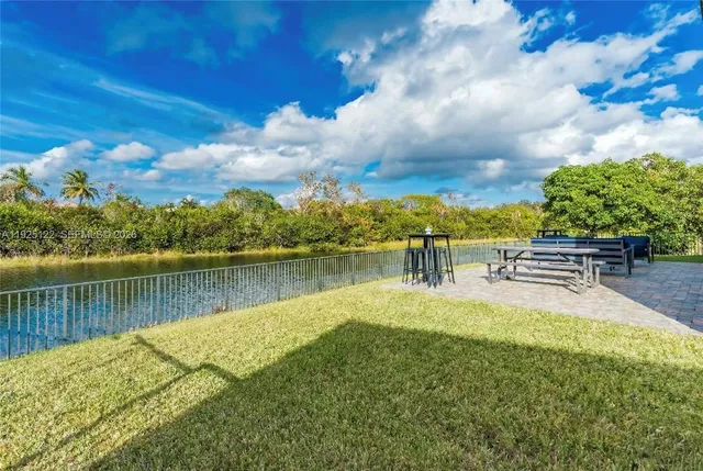 a front view of a house with a yard and a garage
