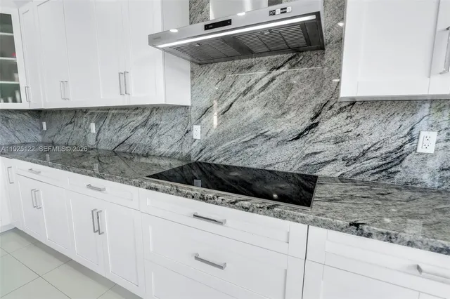 a kitchen with white cabinets and a sink