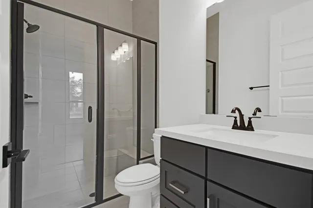 a bathroom with a sink toilet and shower