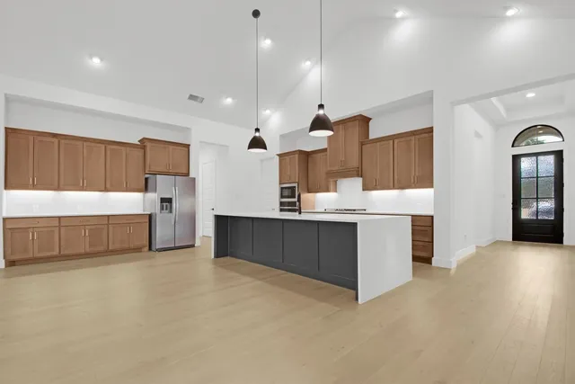 a kitchen with a sink stainless steel appliances and white cabinets