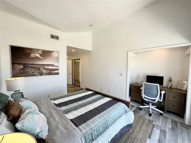 a bed sitting in a bedroom next to a window