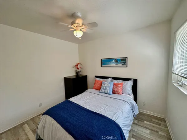 a bedroom with a bed and painting on the wall