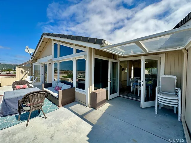 a table and chairs sitting in front of yellow door