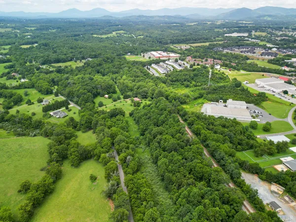 an aerial view of residential houses with outdoor space and swimming pool