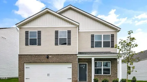 a view of a house with a yard and balcony