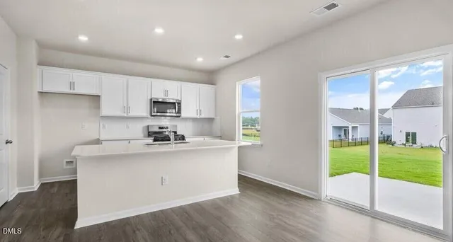 a kitchen with stainless steel appliances granite countertop a stove a sink and a refrigerator