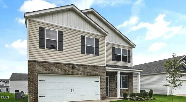 a front view of a house with garage