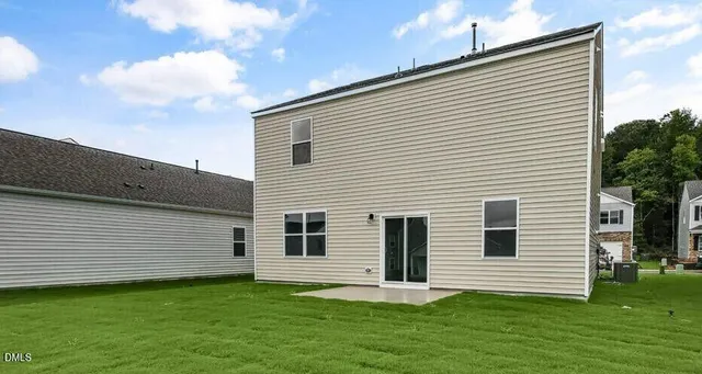 a view of a house with a backyard