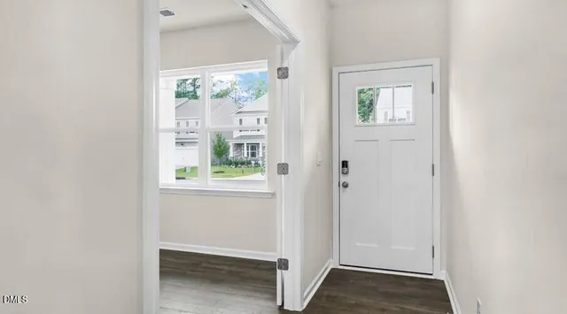 a view of small space with wooden floor and windows