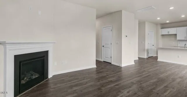 a view of a hallway with wooden floor and a fireplace
