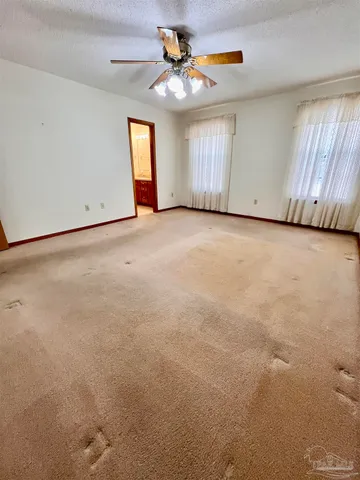 a view of a livingroom with a ceiling fan and window