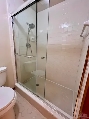 a bathroom with a shower and toilet