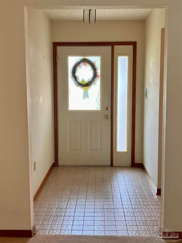 a view of a livingroom with wooden floor and window
