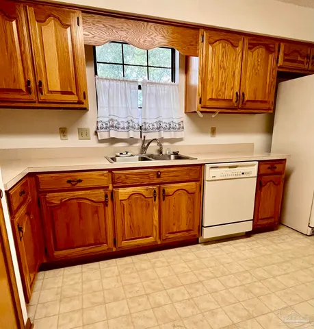 a kitchen with wooden cabinets