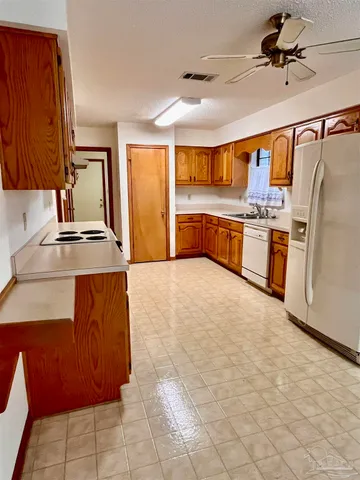 a kitchen with stainless steel appliances granite countertop a sink and cabinets