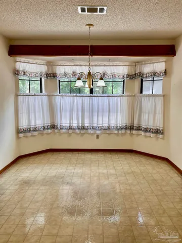 a view of a back yard from a room with a large window