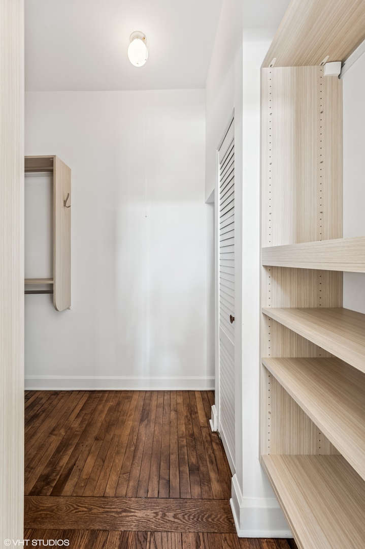 2137 West Cortez Street, Unit 2 Chicago, IL 60622 - Photo 15 of 19 a view of a hallway with wooden floor and cabinet