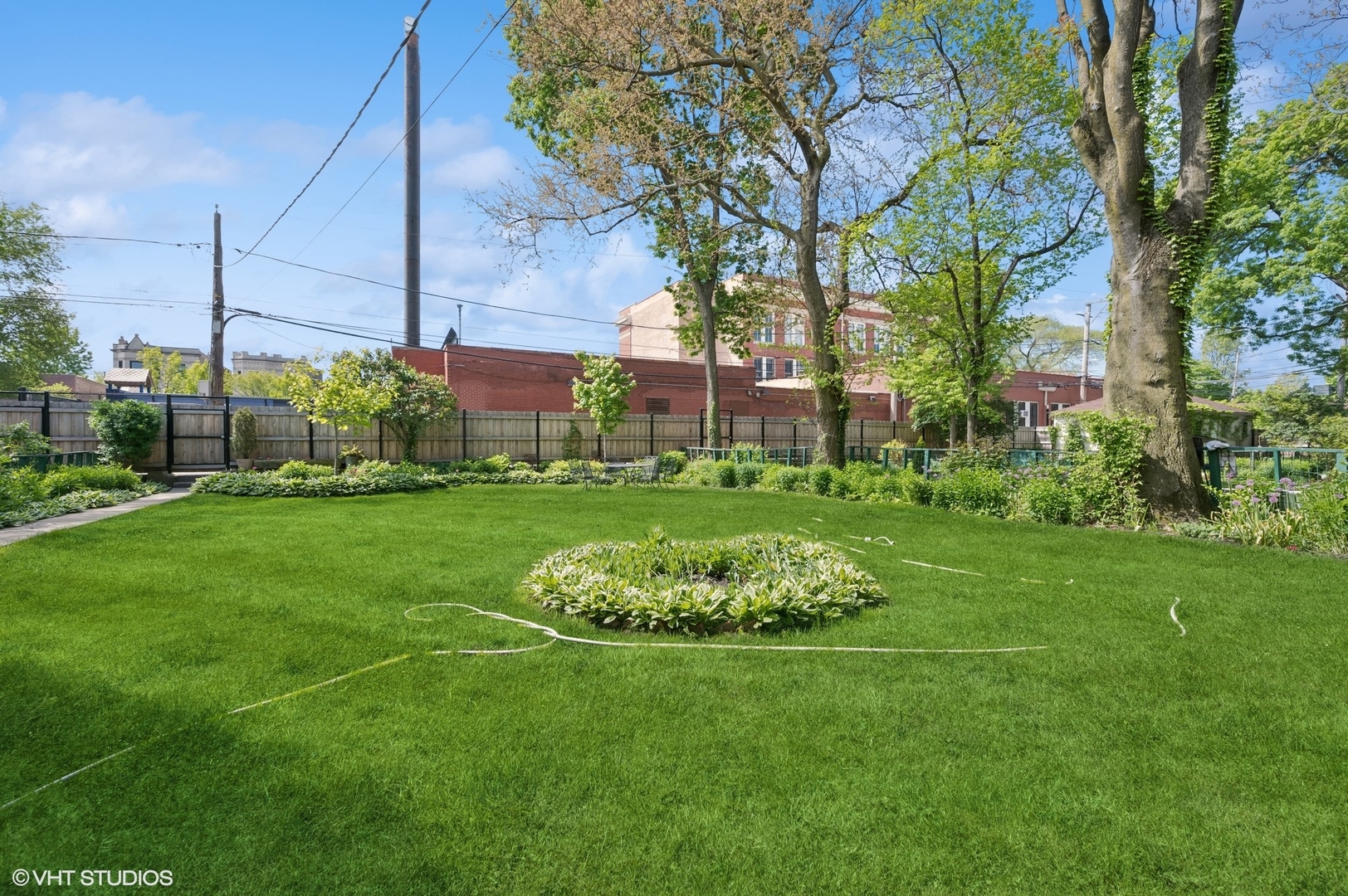 2137 West Cortez Street, Unit 2 Chicago, IL 60622 - Photo 17 of 19 a view of a white house with a big yard and potted plants